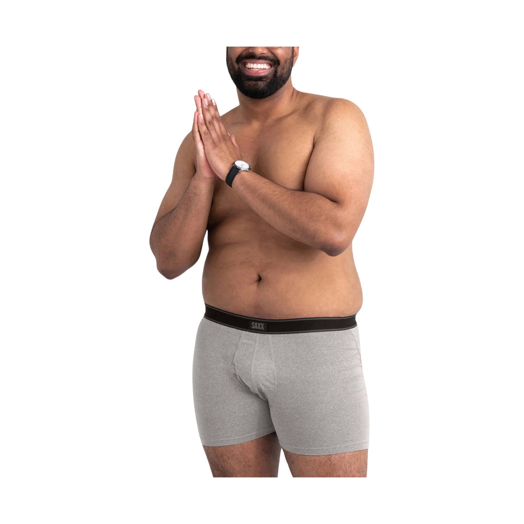 Gray boxer briefs with black SAXX waistband, shown on a model