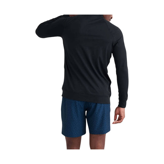 Black long-sleeve athletic top and blue patterned shorts shown from the back