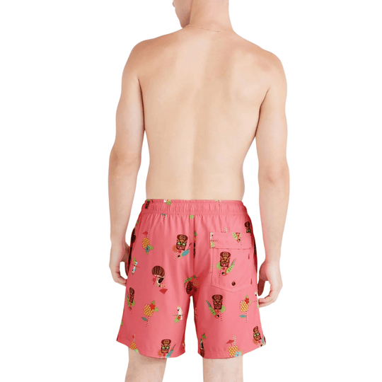 Pink swim trunks with a colorful tropical print, back view