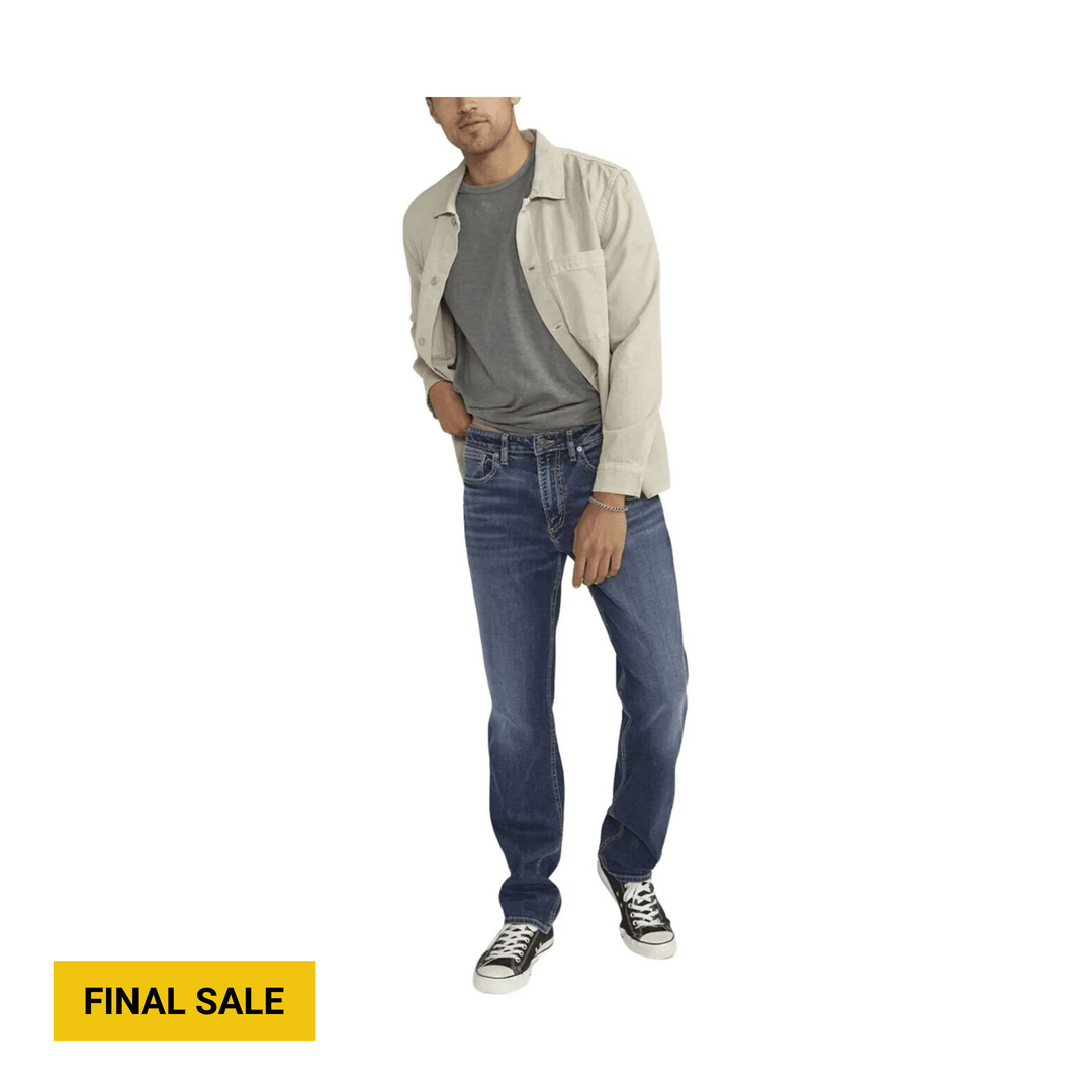 Man wearing light beige overshirt, gray T-shirt, blue straight-leg jeans, and black low-top sneakers with white laces; FINAL SALE text