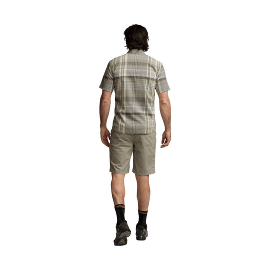 Men's short-sleeve plaid shirt in muted gray and olive, shown from the back with tan shorts