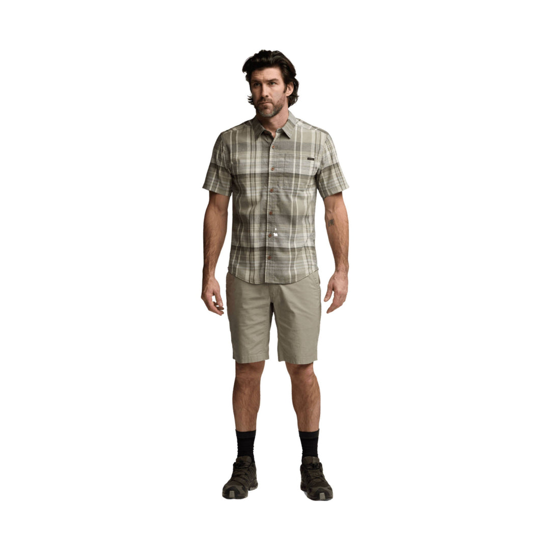 Men’s short-sleeve plaid button-up shirt with khaki shorts and hiking shoes