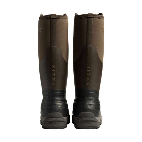 Brown and black tall rubber boots with textured soles, rear view