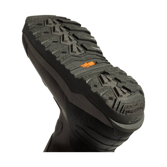 Black boot sole with deep lug tread and a small orange logo mark