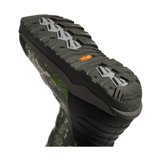 Black boot outsole with deep lug tread and orange logo detail
