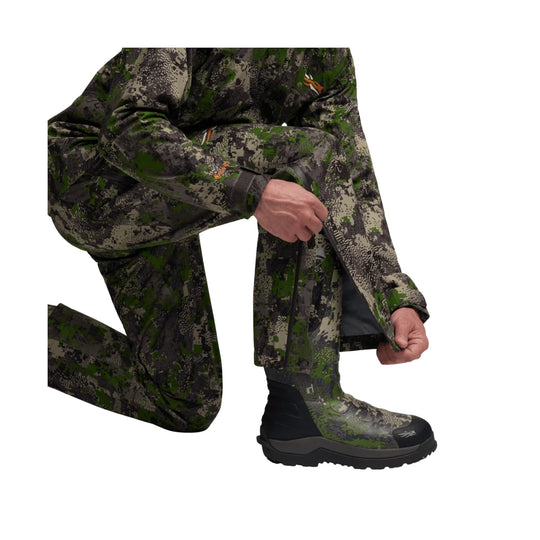 Camouflage insulated pants with a waterproof shell, shown with a kneeling model and black winter boot