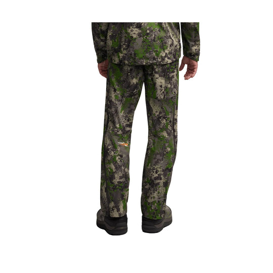 Back view of camouflage outdoor pants worn with matching jacket and black boots