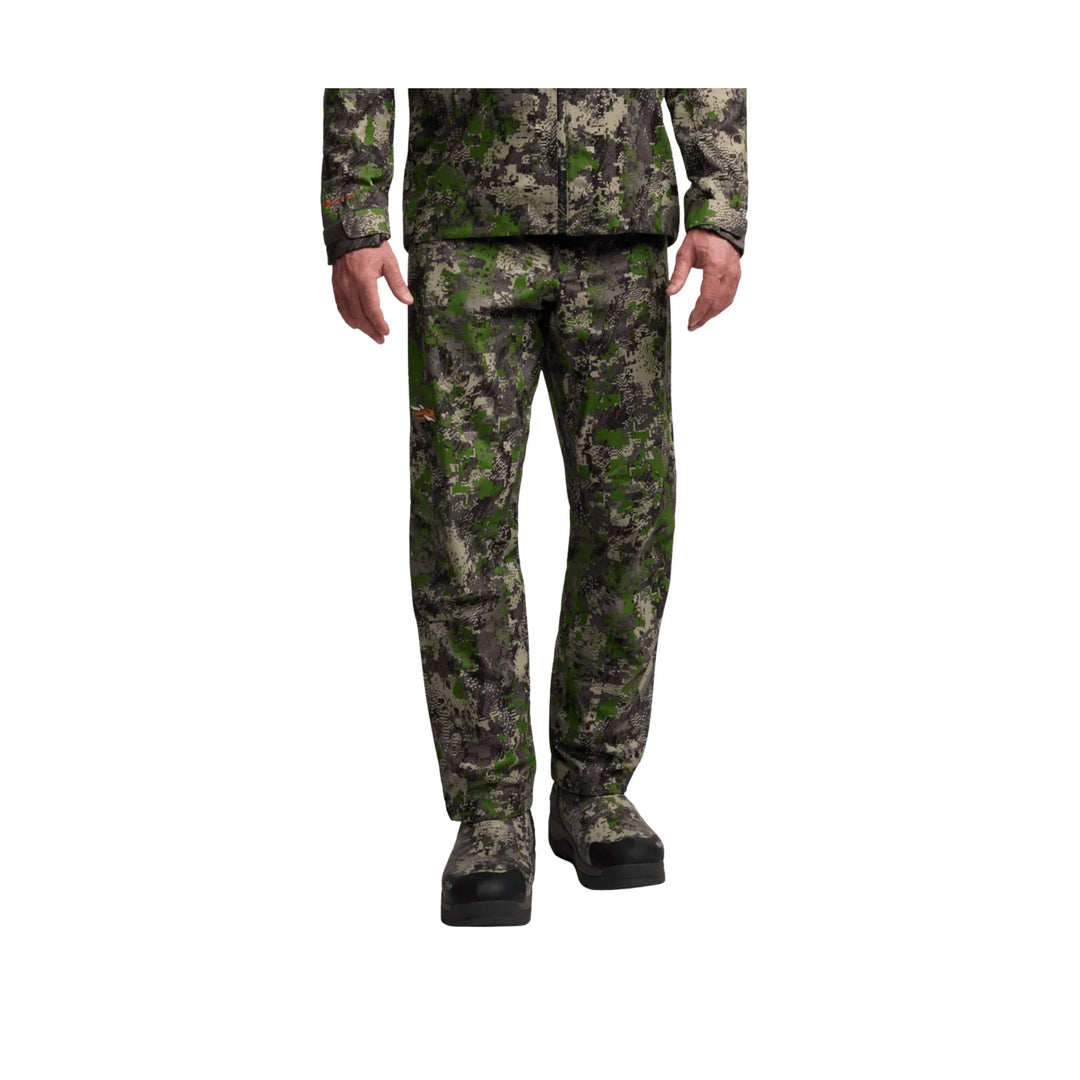 Camouflage waterproof pants shown on a model from waist to boots