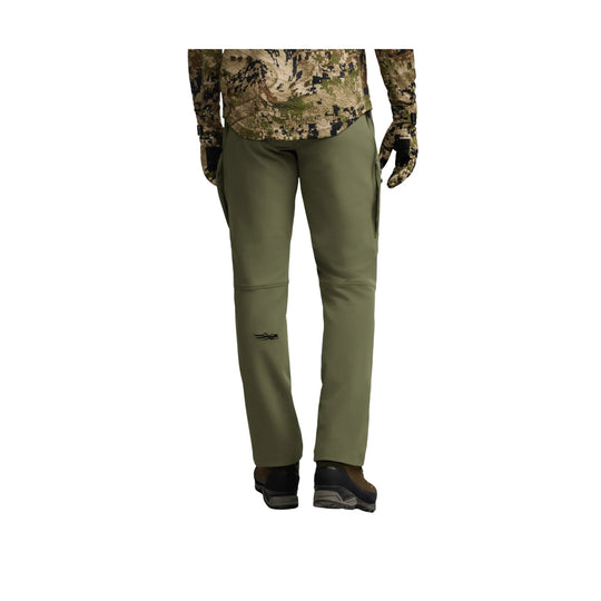 Olive green hiking pants with a camouflage waistband, articulated knees, and ankle cuffs