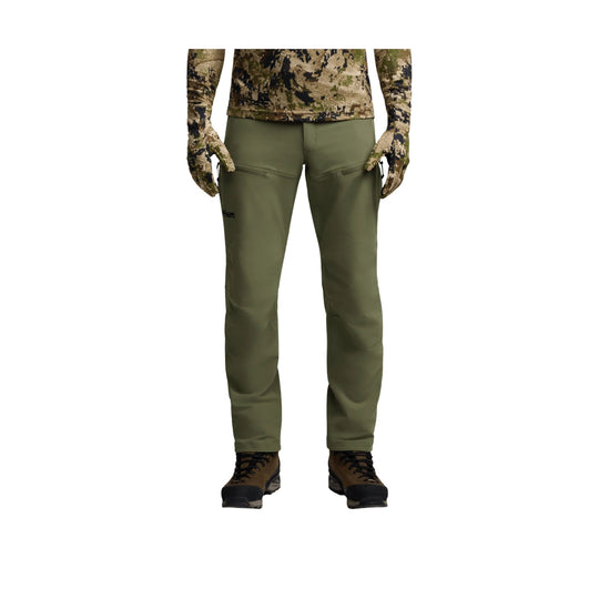 Olive green hiking pants with zip thigh pockets, shown on a model from waist to boots