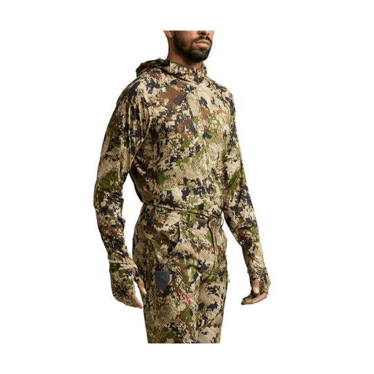 Camouflage hooded long-sleeve top with matching pants, shown on a model against a white background