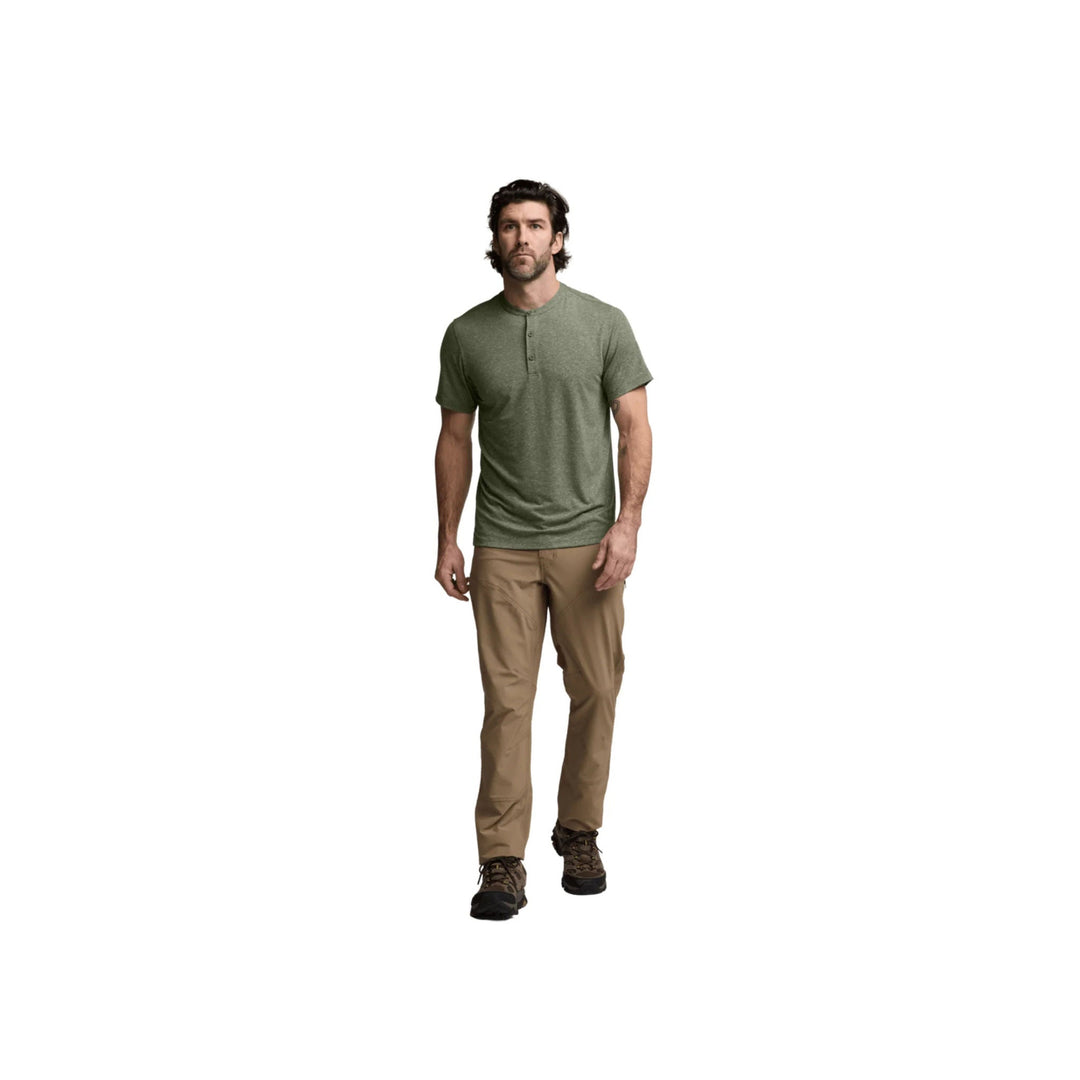 Olive short-sleeve henley shirt with three-button placket and tan hiking pants on a model