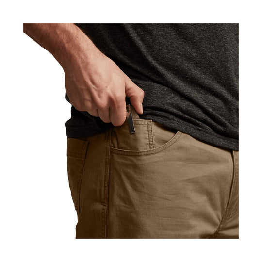 Tan straight-leg pants with a side hand pocket and zippered pocket detail