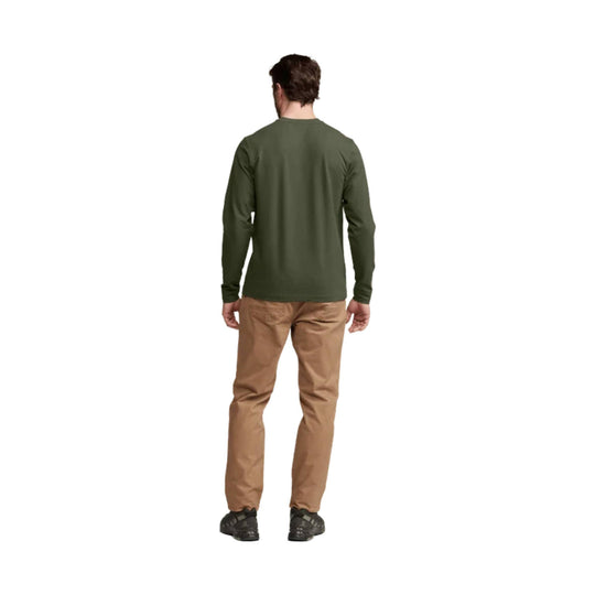 Olive long-sleeve crew neck shirt shown from the back with tan pants