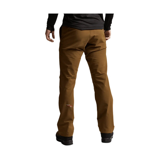 Brown hiking pants shown from the back on a model