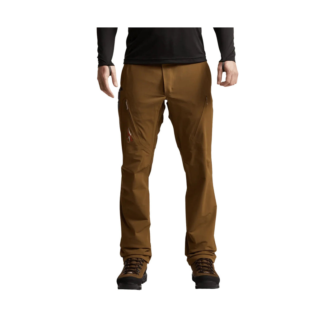 Brown men’s hiking pants with zip thigh pockets and brown hiking boots