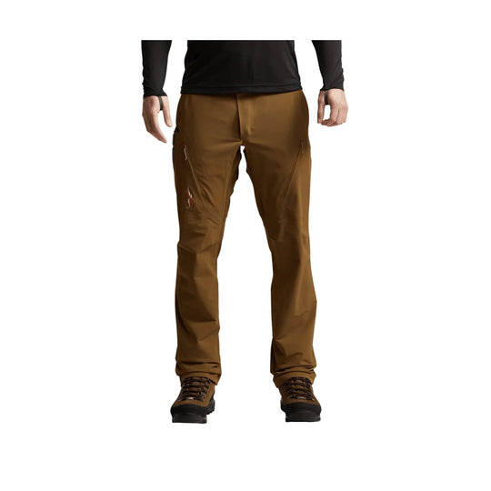 Brown men’s hiking pants with zip thigh pockets and brown hiking boots