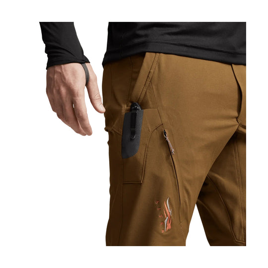 Brown technical pants with a side zip pocket and vertical logo on the thigh