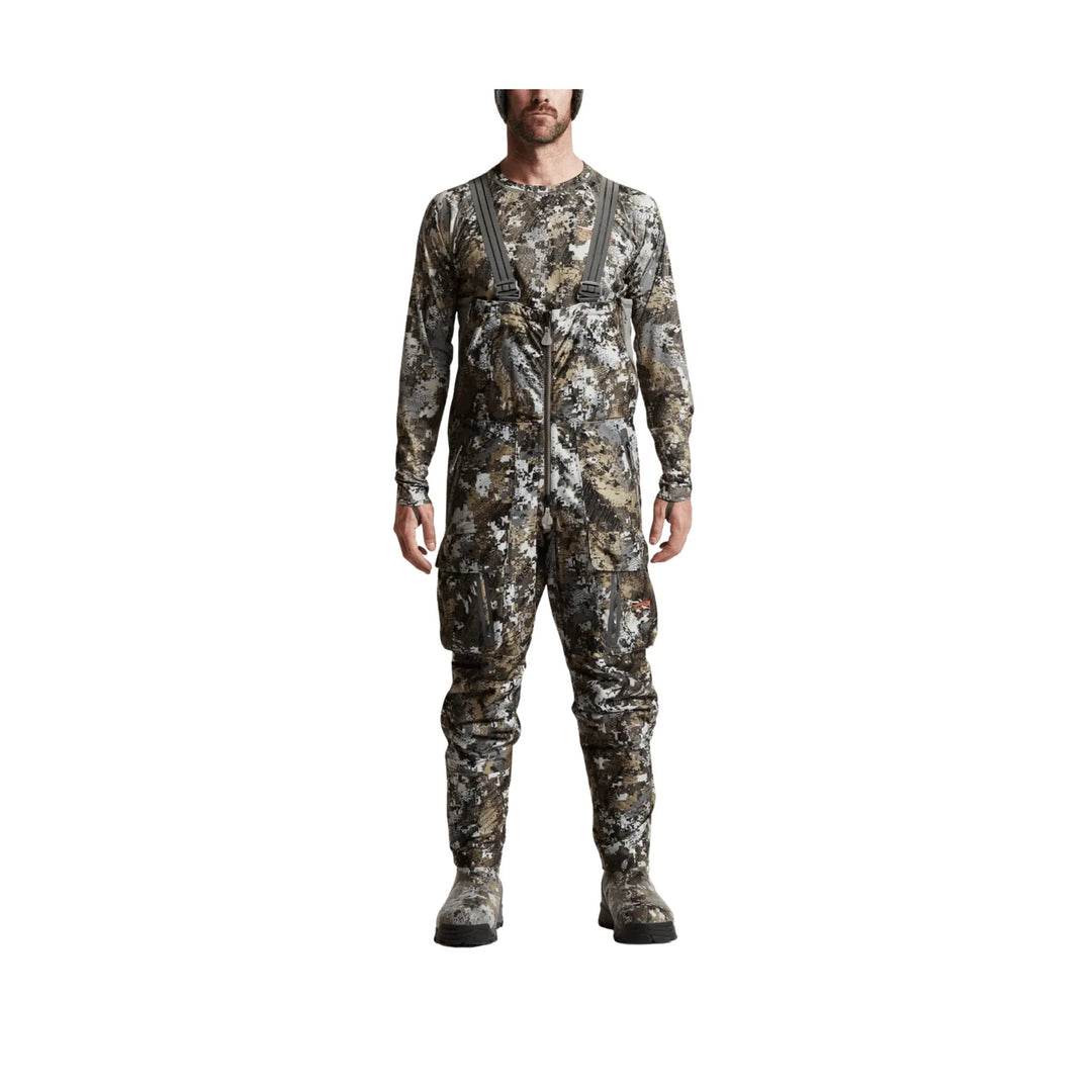 Camouflage hunting bib overalls with suspenders, front zipper, and boot covers