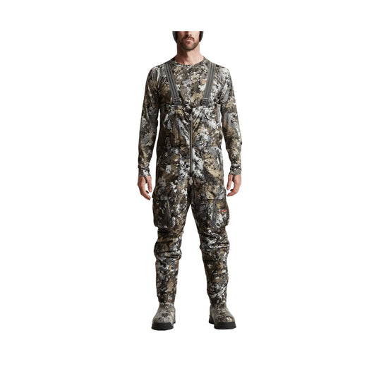 Camouflage hunting bib overalls with suspenders, front zipper, and boot covers