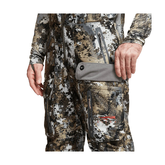Camouflage insulated bib pants with multiple zippered cargo pockets and a gray flap pocket