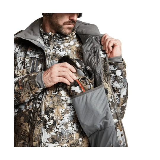 Camouflage insulated jacket worn open, showing gray inner lining and a zip chest pocket.