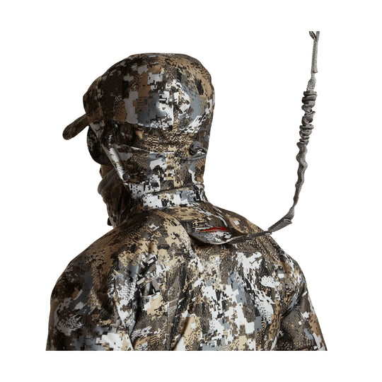 Camouflage jacket shown from the back with hood up and a dangling strap