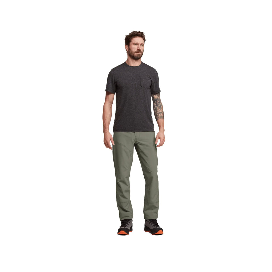 Olive green straight-leg hiking pants worn with black trail shoes