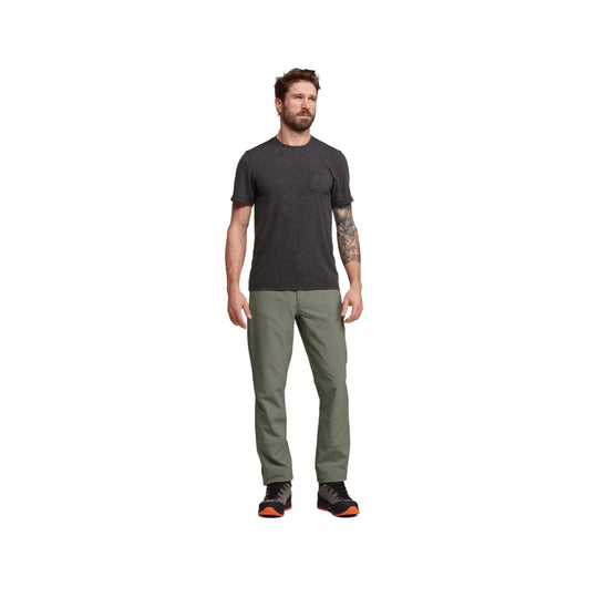 Olive green straight-leg hiking pants worn with black trail shoes