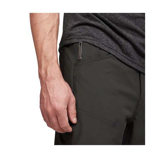 Dark men's pants with stitched seams and a small side zipper pocket clip
