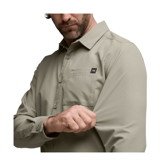 Light olive button-up shirt with chest pocket and long sleeves, shown on a man against a white background