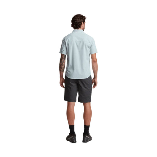 Light blue short-sleeve button-up shirt shown from the back with dark shorts