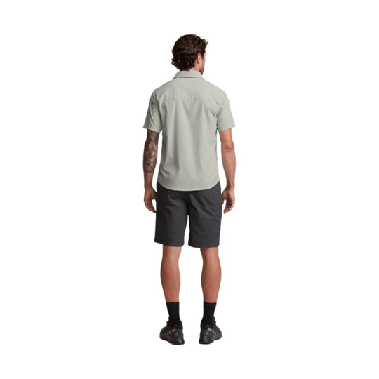 Light gray short-sleeve button-up shirt shown from the back, paired with dark shorts