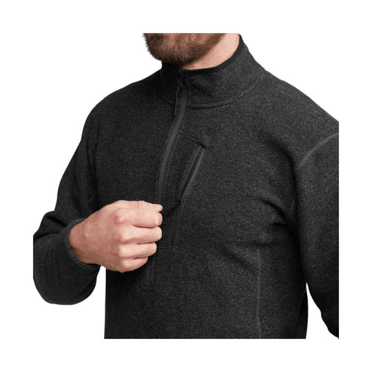 Dark zip-up fleece pullover with a high collar, chest pocket, and textured knit fabric