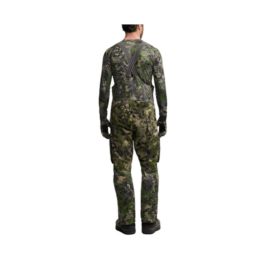 Camouflage bib pants shown from the back with suspenders and boot cuffs