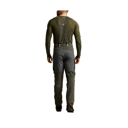 Men's olive long-sleeve pants with gray knee and seat panels, shown from the back with suspenders
