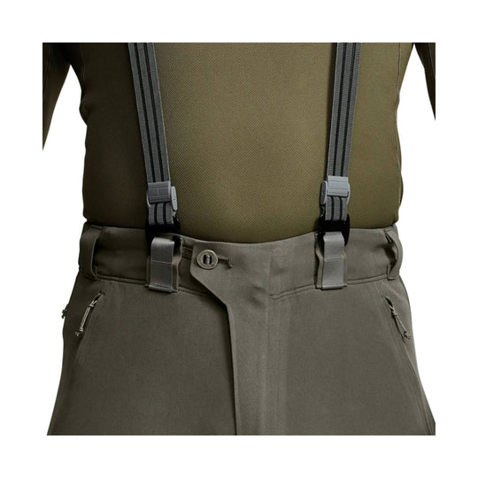 Olive hiking pants with attached suspenders, front waist view