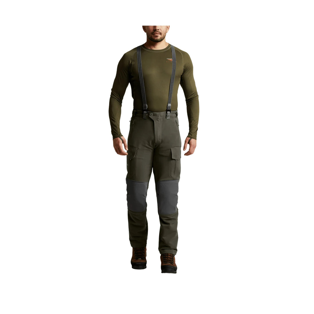 Olive outdoor pants with suspenders, cargo pockets, and reinforced knee panels