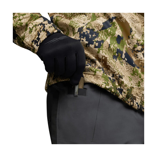 Black technical pants with a zip pocket, shown with a camo jacket and black glove