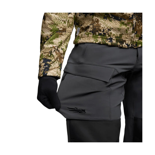 Camouflage snow pants with black gloves and a gray cargo panel