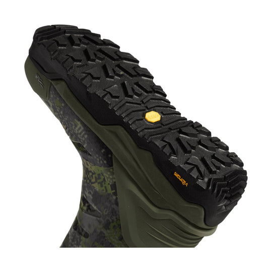 Black and olive high-traction hiking boot sole with deep tread and a camouflage upper