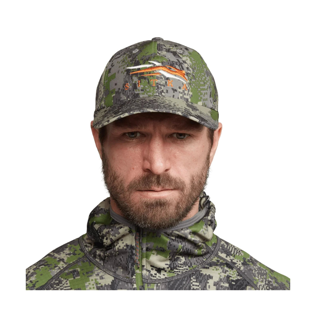 Camo baseball cap and matching zip-up neck gaiter with SITKA logo