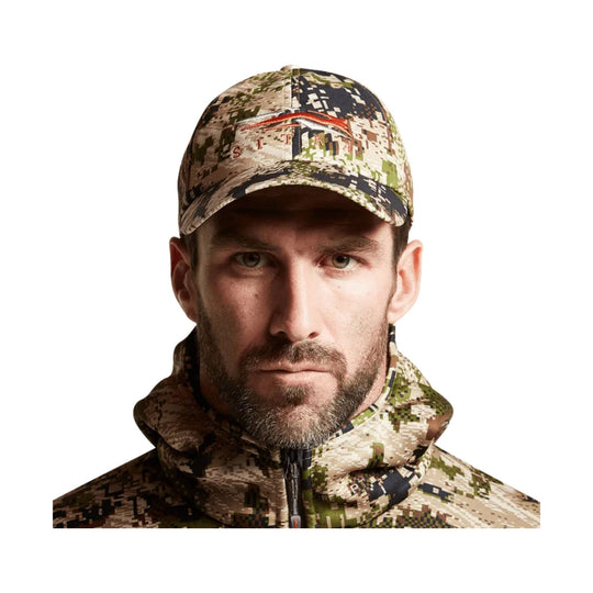 Camouflage baseball cap and matching zip-up jacket with a high collar