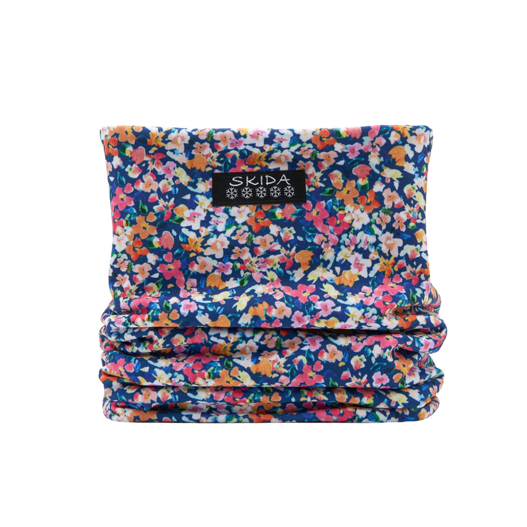 Floral patterned fleece neck warmer with a black Skida label