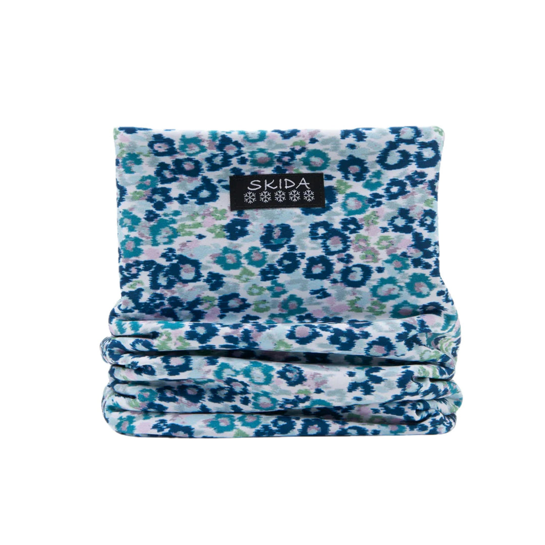 Folded floral fleece neck warmer with a SKIDA label