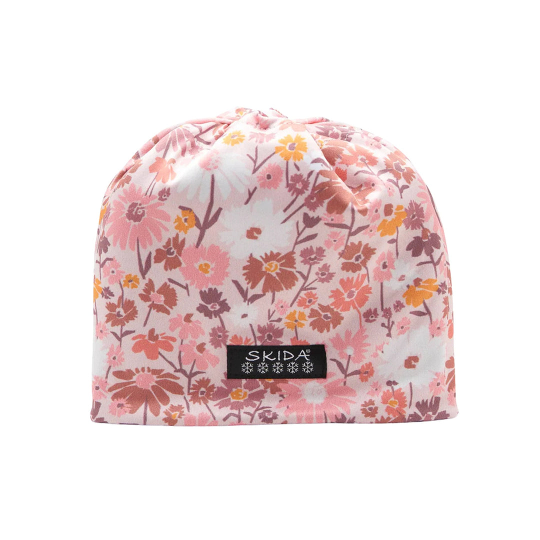 Pink floral knit beanie with a black SKIDA logo patch