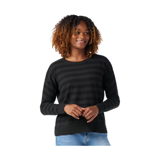 Black striped crewneck sweater worn with light blue jeans