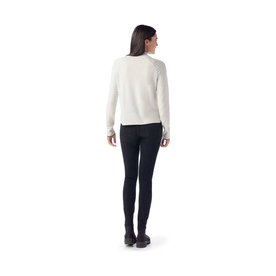 Light cream long-sleeve mock neck sweater shown from the back with ribbed sleeves and hem