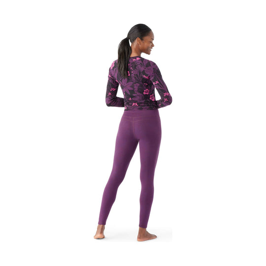 Purple leggings with a fitted black-and-pink floral long-sleeve top, shown from the back