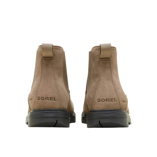 Pair of tan suede Chelsea boots shown from the back with black lug soles and pull tabs